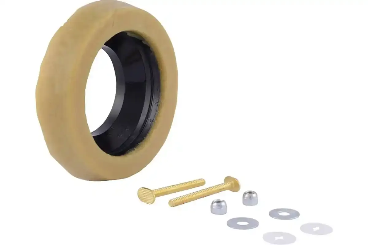 Toilet wax ring with closet bolts and washers laid out on a white surface